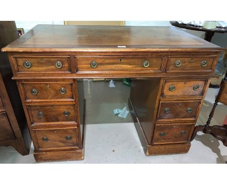 A late 19th/early 20th century mahogany kneehole desk with inset leather top, 3 frieze and 6 pedestal drawers with ring handl