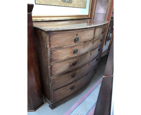 A Georgian style mahogany bow front chest of 4 long and 2 short drawers, ring handles and bracket feet