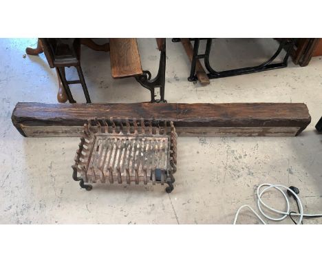 A cast iron dog grate; an oak rustic overmantel 