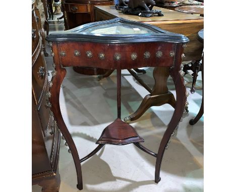 A triangular display table with lower shelf 