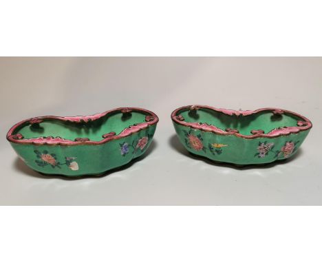 A pair of Chinese kidney shaped canton enamel brush pots decorated with pink and blue flowers against a turquoise ground and 