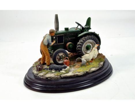  A static presentation piece comprising a Country Artists model featuring a Field Marshall Tractor. Fine Model with Box.