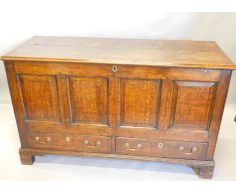 An early 18thC oak mule chest, the hinged top with a moulded edge, enclosing a vacant interior with a candle box, above a qua