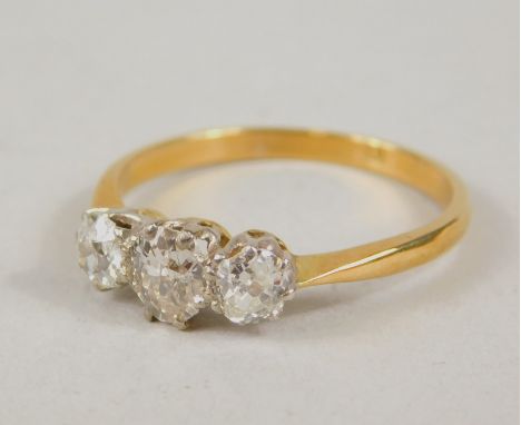A three stone diamond ring, comprising Victorian stones , each claw set, on a plain shank, unmarked, 2g all in