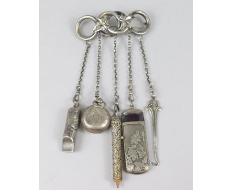 An early 20thC ladies part Chatelaine, the entwined circular top with chain ends holding whistle sovereign case, button hook 