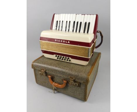 A mid 20thC Hohner Piccola accordion, with twelve buttons, 30cm wide (cased)