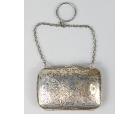 An Edwardian silver evening purse, of small proportion, the oblong body chased with scrolls with a cane and ring handle, fitt