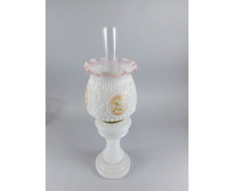 A late Victorian pressed milk and clear glass oil lamp, with shaped floral shade, raised with a geometric upper banding and f