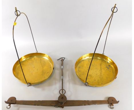 A brass and cast metal scale, with two circular pans on wirework frames, centred by a heavy metal section, 36cm high, 70cm wi