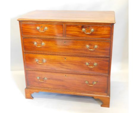 An early 19thC mahogany chest of drawers, the rectangular top with a moulded edge above two short and three long drawers, wit