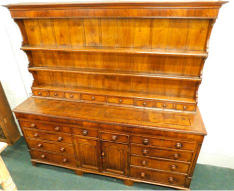 A 19thC Lancashire type oak and mahogany crossbanded dresser, the plate rack with three shelves and eight drawers, the base w