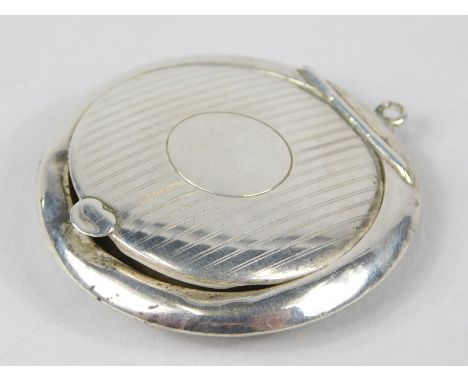 A George VI silver circular patch or make up box, with engine turned lid, mirrored back and silver gilt interior, with hook t