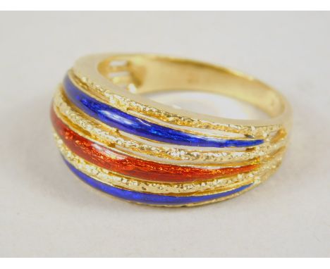 A Continental dress ring, set with sections of red and blue enamel finish stripes, on a textured part pierced shank, marked K