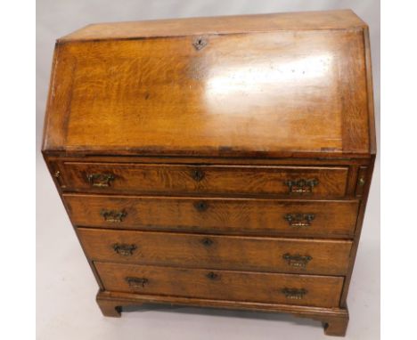 An 18thC oak bureau, the fall front hinging to reveal a part fitted interior with cupboard, drawers and pigeon holes with a c