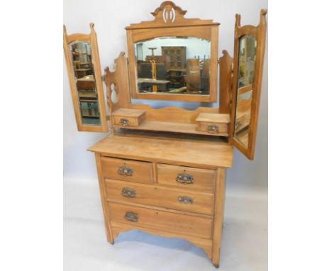 A Victorian stripped walnut dressing chest, the raised back with three bevelled mirror plates, and two trinket drawers, on pi