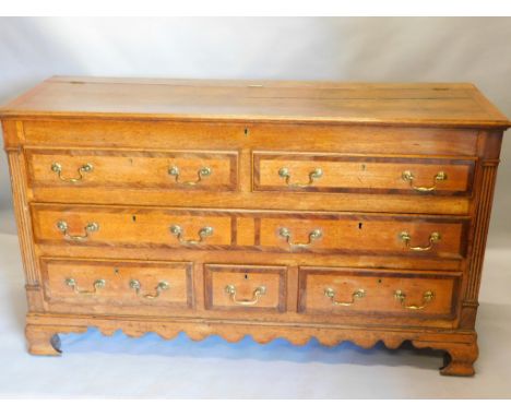 An 18thC oak and mahogany crossbanded Lancashire type chest, the hinged lid enclosing a vacant interior, with two false drawe