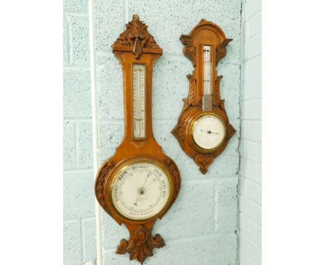 A late 19th/early 20thC aneroid barometer, in carved oak case, with applied thermometer, retailed by Mansell of Lincoln, 89cm