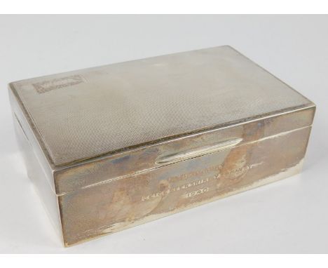 A George V silver cigarette box, the engine turned lid with handle revealing a cedar lined interior, marked to exterior A Bat