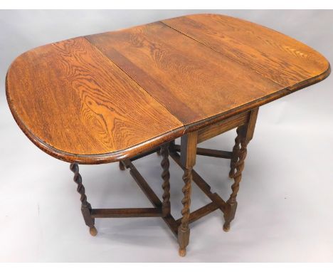 An early 20thC oak dropleaf barleytwist table, with D-end top and gate leg action, on teardrop supports, (when closed) 74cm h