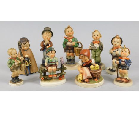 Nine Hummel figures, to include a boy playing a clarinet, child with a lantern, girl with chicks etc.