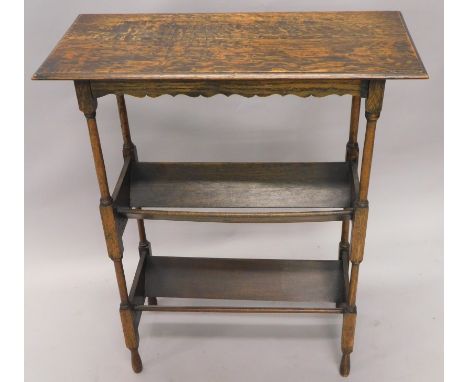 An early 20thC oak free standing book trough, the rectangular over hanging top raised above two sections for books on elongat