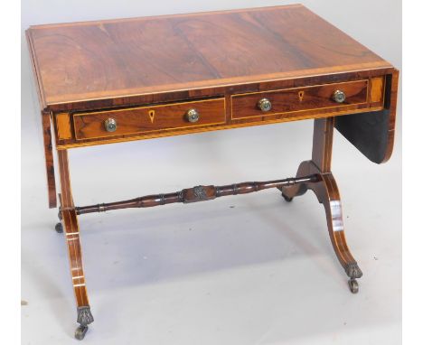 An early 19thC rosewood sofa table, the D end top with a wide cross banding of good definition, raised above two frieze drawe