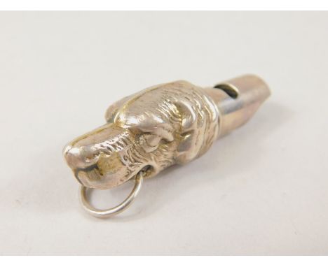 An early 20thC white metal dog head whistle, with ring handle and shaped end, marked 925, 5cm wide