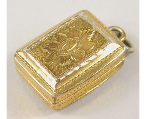 A George IV silver gilt miniature vinaigrette, of rounded oval form, with hinged lid and pierced articulated centre section w