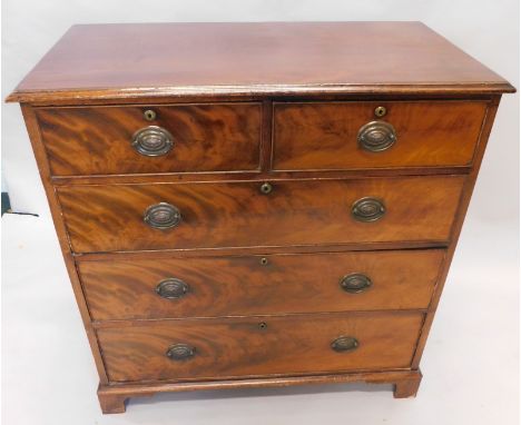 An early 19thC flame mahogany and mahogany chest, the moulded over hanging top raised above two short and three long cockbead