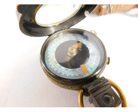 A First World War military brass compass, stamped S. Mordan & Co 1917, the associated leather carrying case stamped T French 