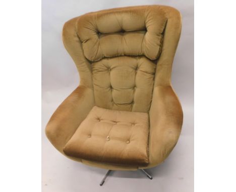 A 1960's/70's Arne Jacobsen style egg shaped armchair, later upholstered, with button back and seat, on a chrome plated swive