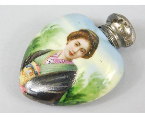 An Edwardian silver painted enamel perfume bottle, of heart shaped outline with screw top decorated with a figure of a Geisha