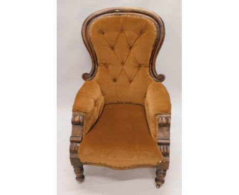 A Victorian spoon back occasional armchair, with button back over stuffed arms and seat in (later) brown material, with a ser
