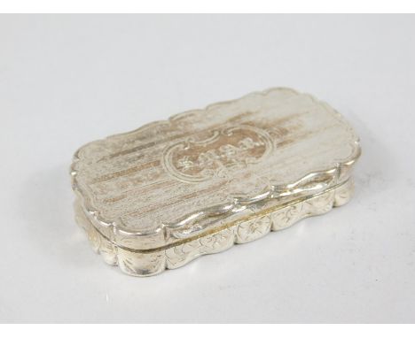 A large mid Victorian silver vinaigrette, with engine turned decoration surrounding a shaped cartouche with owners initials, 