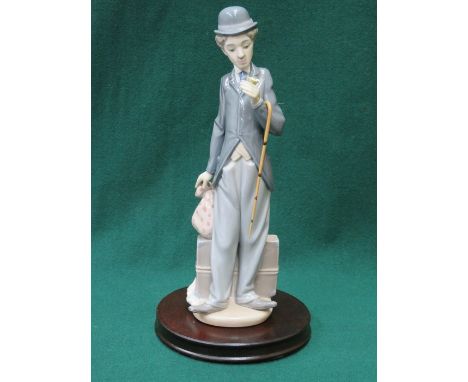 LLADRO GLAZED CERAMIC PIECE OF CHARLIE CHAPLIN ON WOODEN PLINTH 31cm