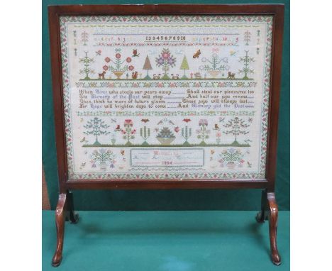 MAHOGANY FIRESCREEN WITH MOUNTED AND GLAZED SAMPLER, DATED 1934 