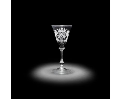 A Dutch engraved armorial light baluster wine glass, circa 1750The generous round funnel bowl slightly flared at the rim, dec