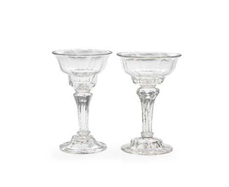 Two moulded-stem sweetmeat glasses, circa 1740-50The panel-moulded lipped double ogee bowls raised on eight-sided pedestal st