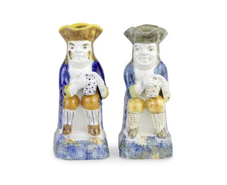 Two Prattware Toby Jugs, circa 1810Of traditional form, seated and holding spotted foaming jugs with both hands, wearing blue