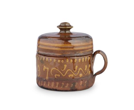 An English slipware posset pot and cover, dated 1797Cylindrical with a small strap handle applied to one side, the red body t