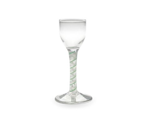 A rare green mixed colour twist wine glass, circa 1765Of attractive small size, the ovoid bowl on a stem containing a central