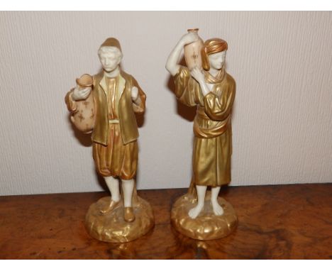 A pair of Royal Worcester figures – Arab water carriers in blush ivory & gilt, 8” high – one water jar chipped to rim