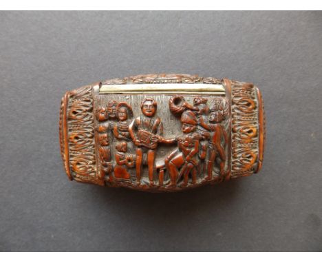 A Napoleonic coquilla nut snuff box, carved in high relief and undercut to depict European figures in the colonies, the hinge