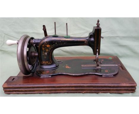 A vintage sewing machine, the iron base of fiddle shape