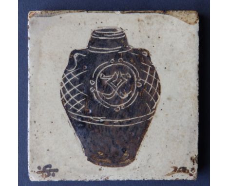 A Bernard Leach pottery tile, painted in brown to depict a two-handled urn with circular panel and cross-hatching, painted st