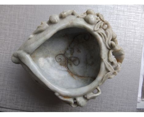 A Chinese jade brush water holder of leaf form, the sides decorated with two under-cut bats and fruiting vine , 5.75” across