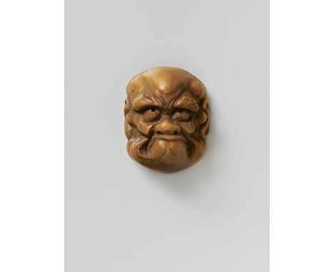 A JAPANESE MASK NETSUKE OF A FROWNING MAN, LATE 19TH CENTURYpale boxwood, unsigned3.8cm high Peter E. Müller Japanese Mask Co