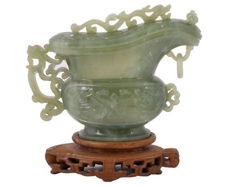 A CHINESE JADE VESSEL AND COVER, 20TH CENTURYof archaistic pouring form, carved with taotie motifs, openwork scrolls and a dr
