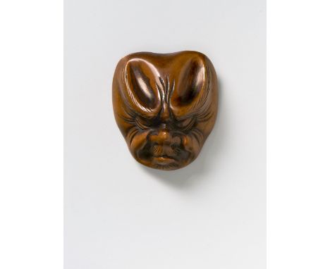 A JAPANESE MASK NETSUKE OF BAKEMONO, 19TH CENTURYwood, unsigned4.3cm high Peter E. Müller Japanese Mask Collection No.207