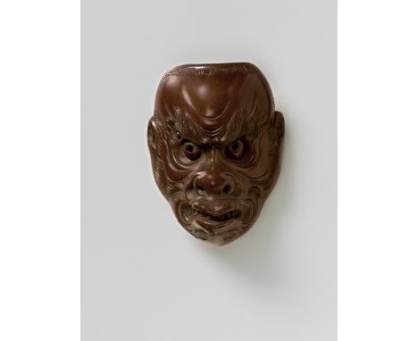 A JAPANESE MASK NETSUKE OF A HIRSUTE DEMON, BY HOZAN, EARLY 20TH CENTURYdark stained polished boxwood, signed ‘nana-ju-issai 